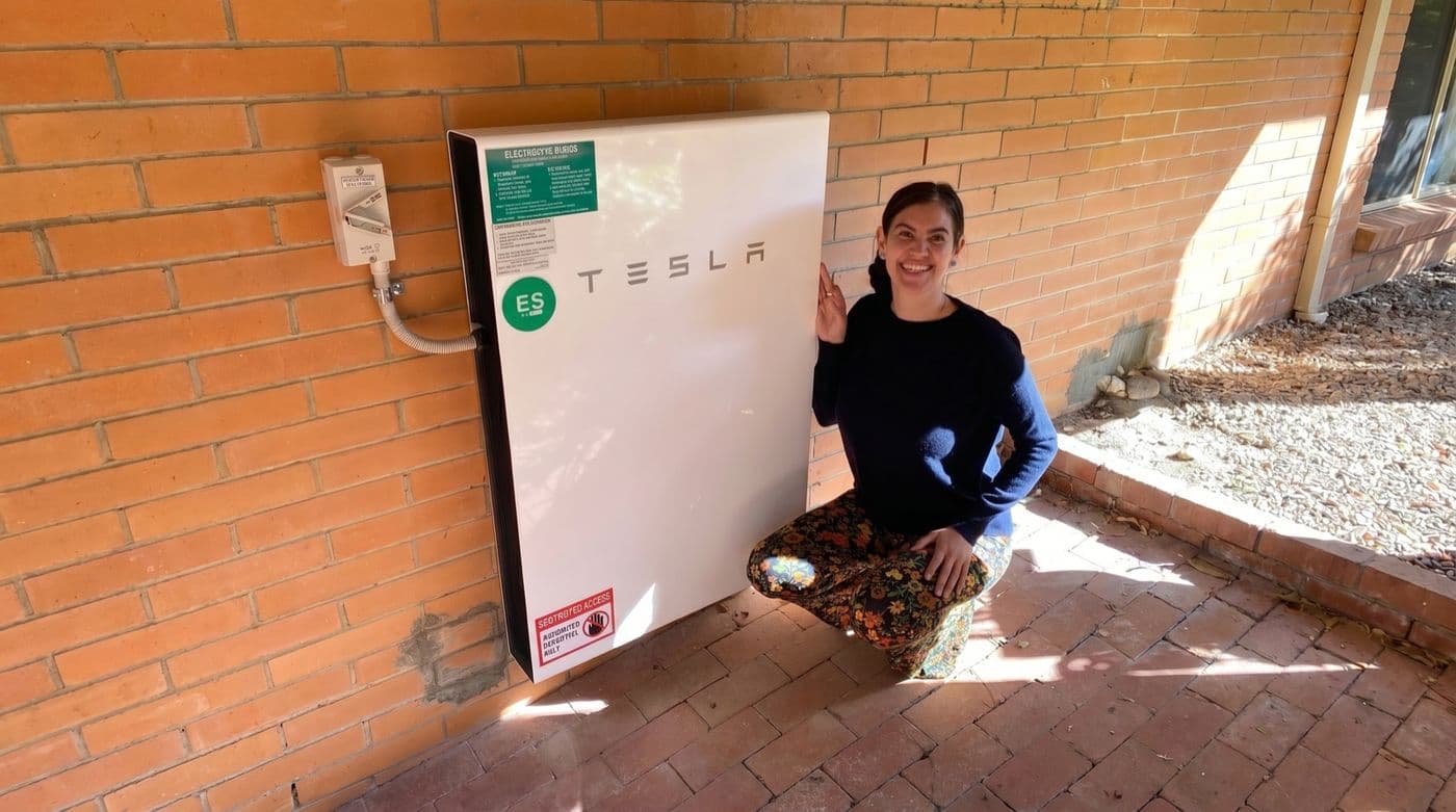 Australian home with rooftop solar panels and a wall-mounted battery