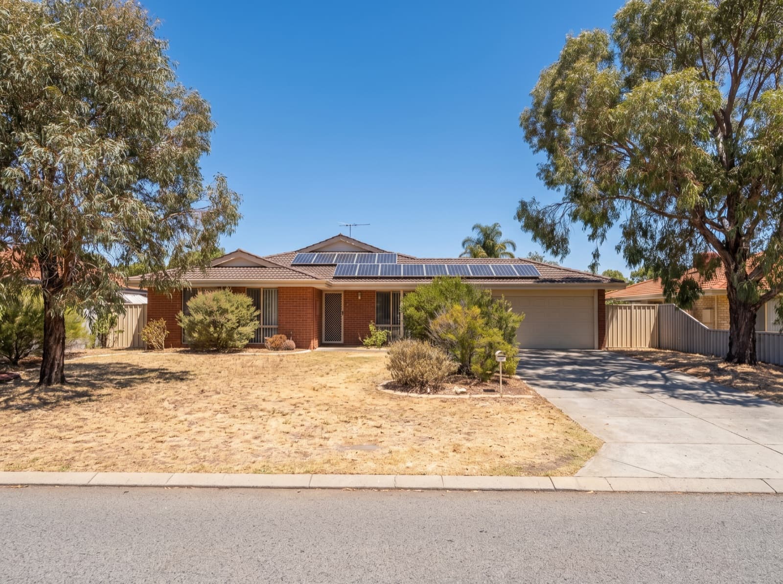 Brick suburban home with rooftop solar in south-east Perth at Gosnells, hot summer day